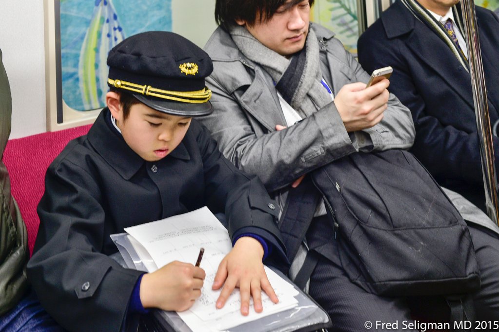 20150309_144258 D4S.jpg - Doing homework on subway, Tokyo